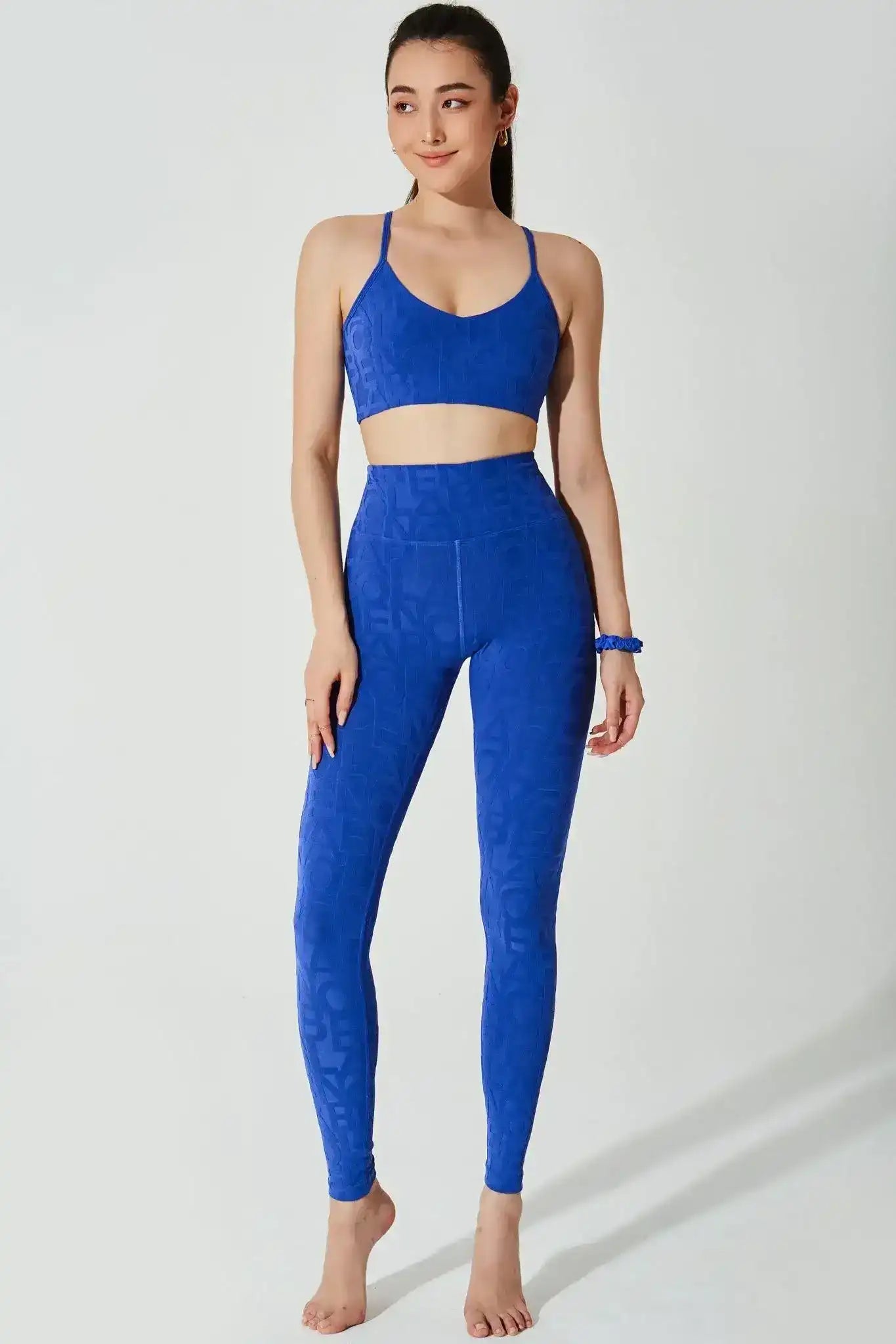 Woman wearing royal blue seamless sports bra and high-waisted leggings for yoga or fitness