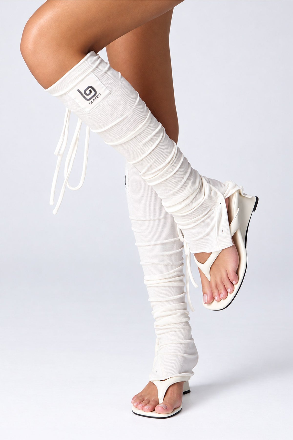 Olaben Barre Ruched Leg Warmers in White, side view showing the side ties