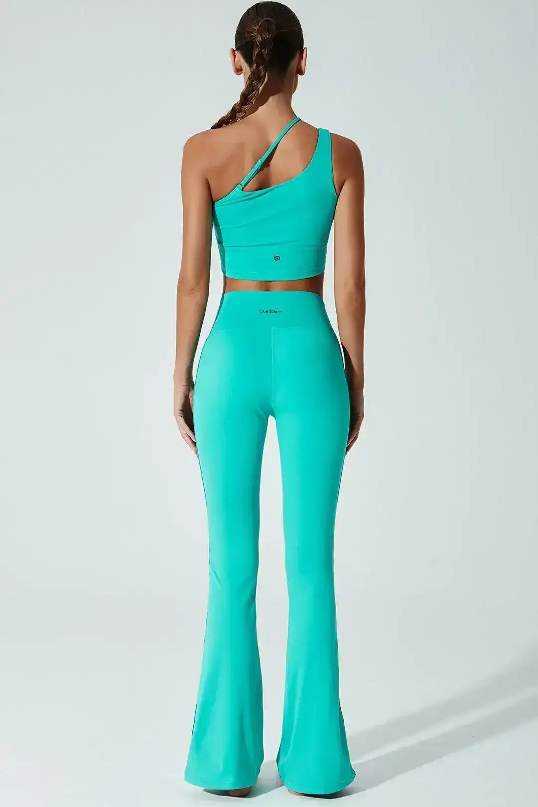 Back view of Olaben Carambolo Top in Java green — one-shoulder back detail, studio shot