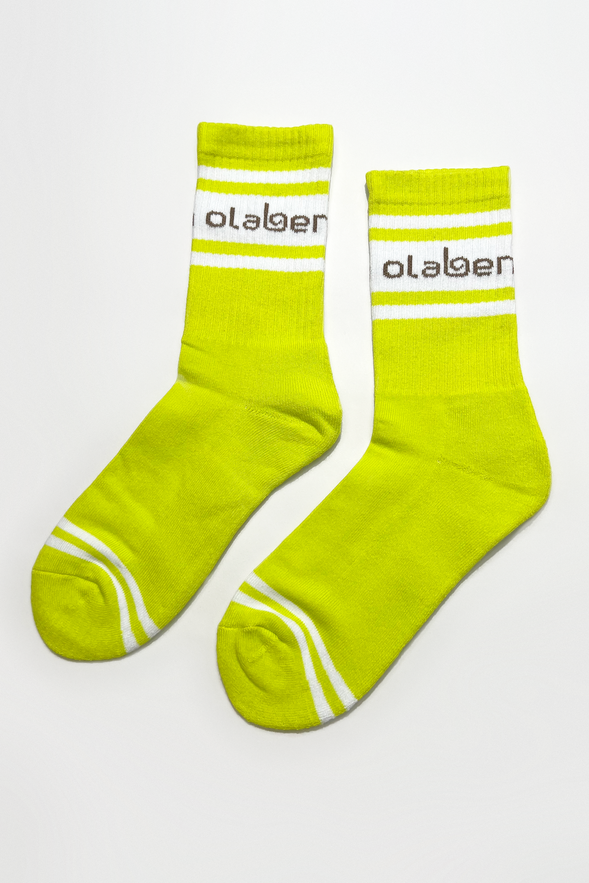 Colorful assortment of socks and lemon tonic on a yellow background - OW-0151-USO-YL_2.png