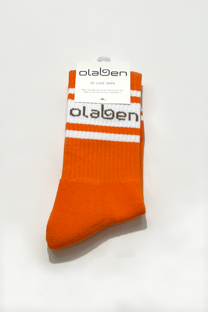 Colorful assortment of socks in sunrise orange, perfect for cozy winter mornings.