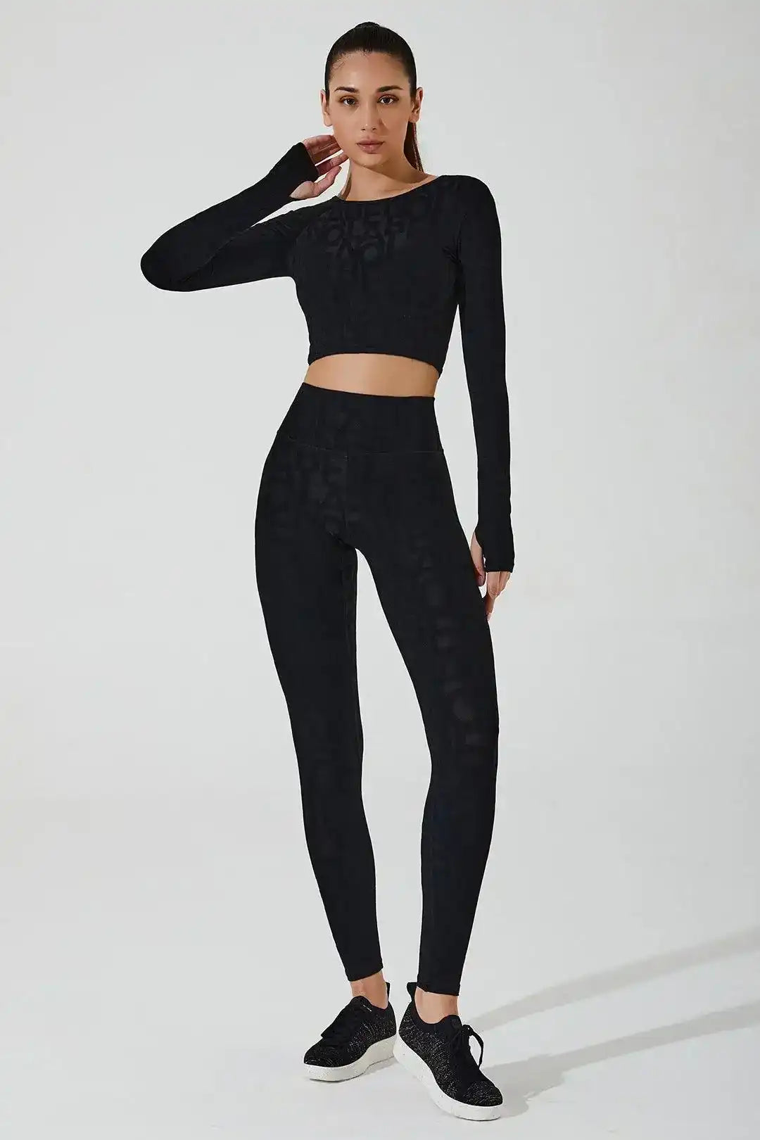 Model in matching Olaben Classic Déese Fleur 3D set — Carbon black embossed leggings and tank top, full-body 3/4 studio shot