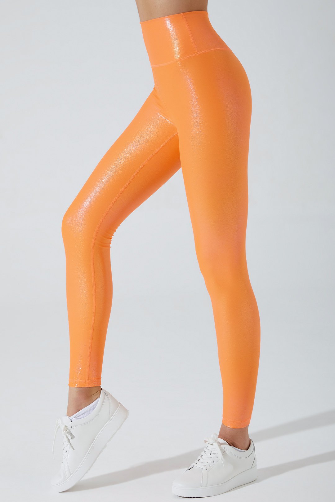 Vibrant jolly orange women's leggings with an iridescent finish, perfect for a stylish look.