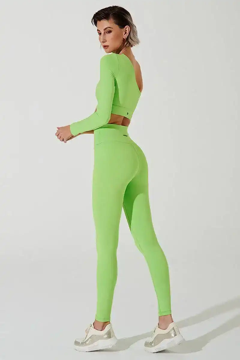 Woman wearing neon green long sleeve activewear set with leggings, posing on white background