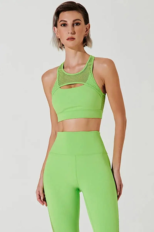 Woman in neon green mesh sports bra and high-waisted leggings, fitness activewear set