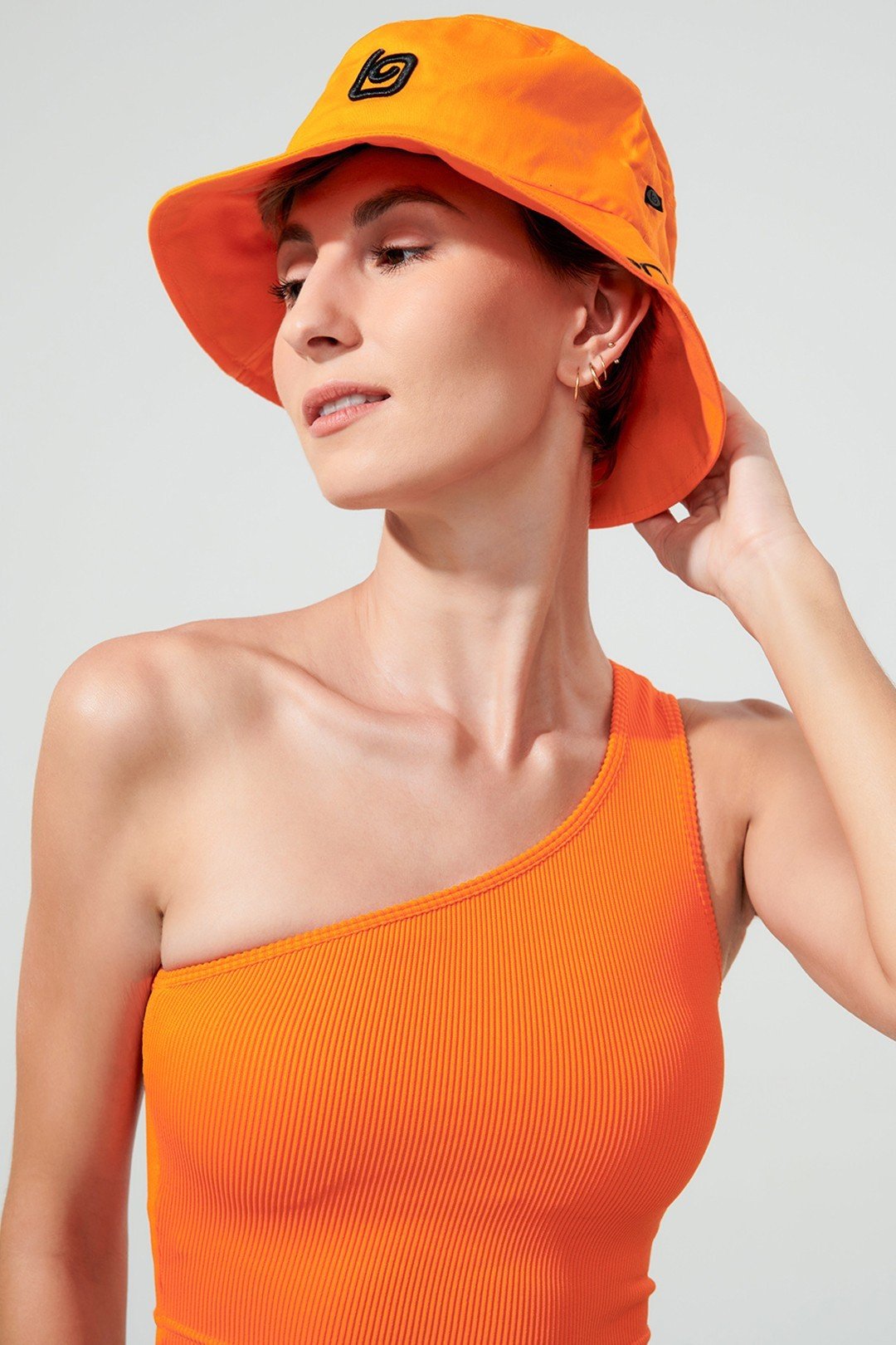 Vibrant orange Jolly bucket hat with OlaBen branding, perfect headwear for a stylish look.