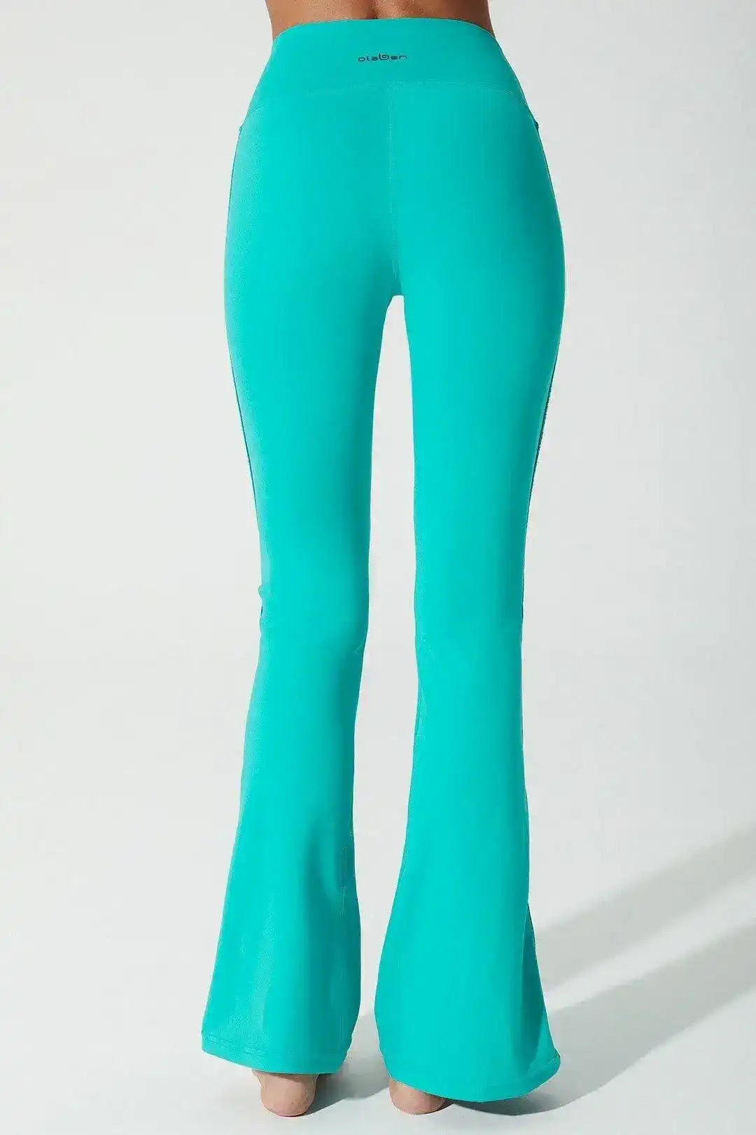 Side view of Olaben Ylang Legging in Java green — sculpted profile, studio shot