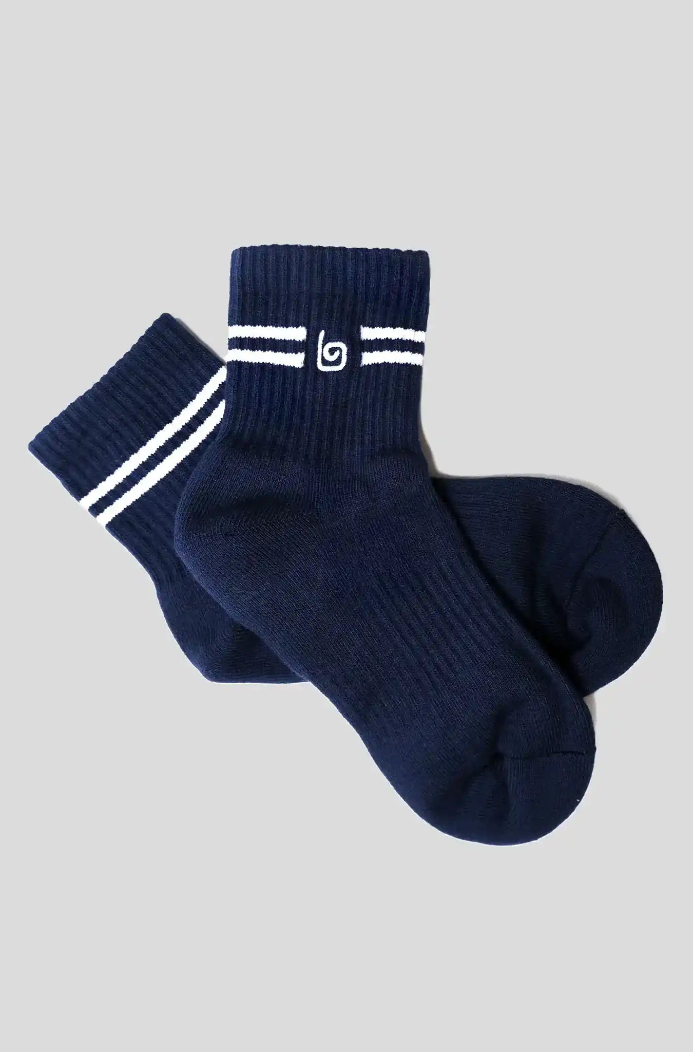 Navy blue athletic socks with white stripes and logo, ideal for yoga and fitness activities.