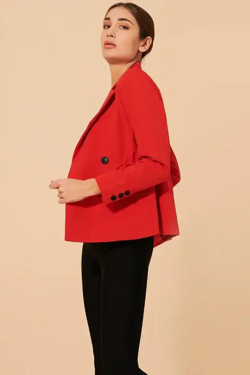 Woman modeling a Persian red blazer jacket with black buttons and fitted sleeves