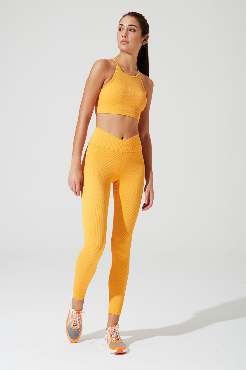 Vivid saffron yellow ribbed leggings for women, a stylish and comfortable choice for any occasion.