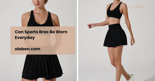 Woman in black sports bra and black pleated skirt, modeling activewear against a plain background.