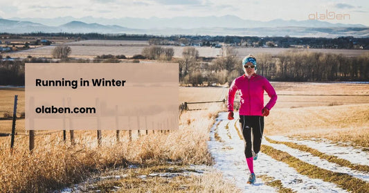 Woman running on a snowy rural trail in winter wearing pink activewear and sunglasses