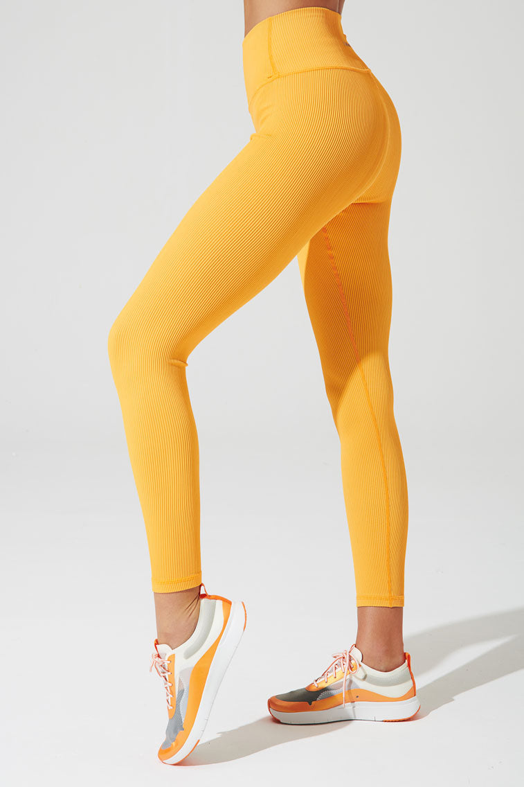 High-waist ribbed saffron orange leggings for women, stylish and comfortable fashion choice.