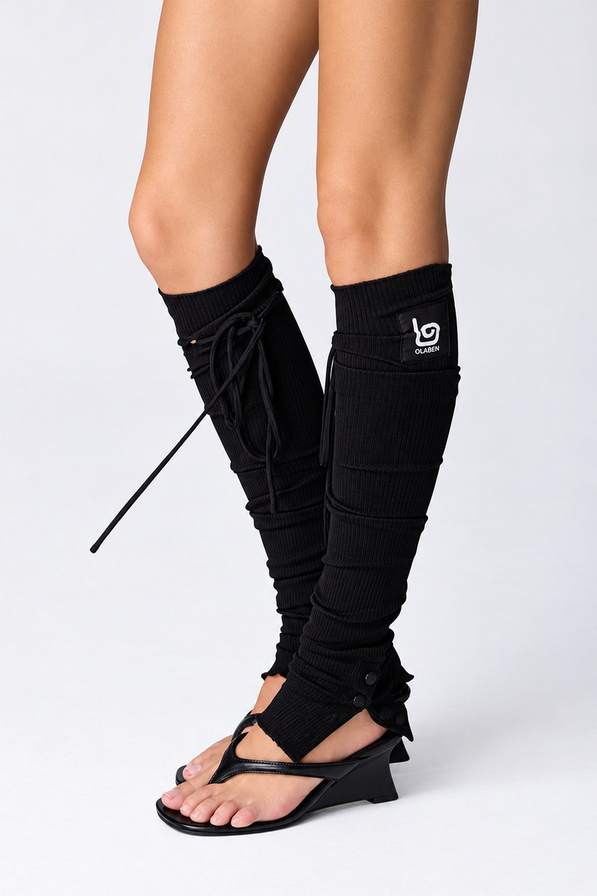 Olaben Barre Ruched Leg Warmers in Midnight showing the stirrup and side ties