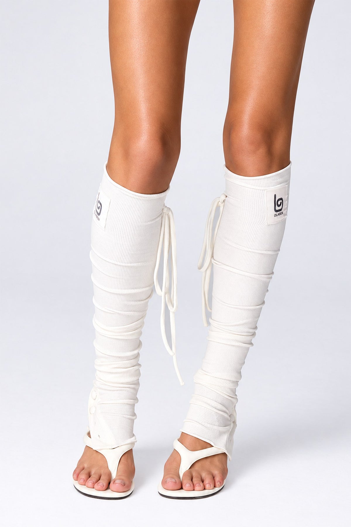 Olaben Barre Ruched Leg Warmers in White, front view of the ruching and stirrup