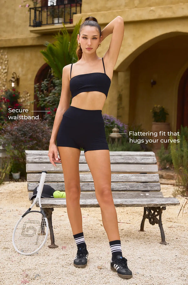 Black activewear set with secure waistband and flattering fit, perfect for tennis and fitness activities.