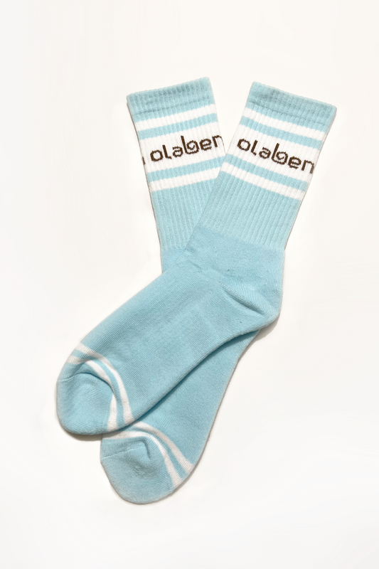 Colorful assortment of socks on a cloud blue background with ice accents.