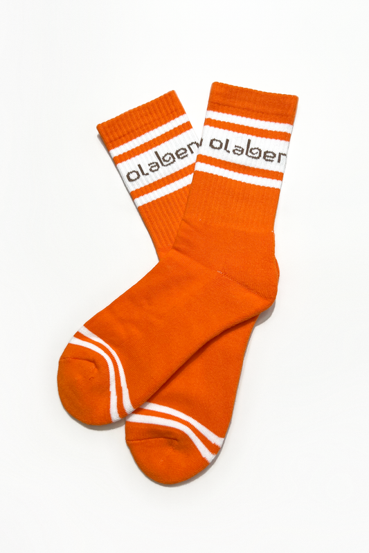 Colorful socks with sunrise orange pattern, perfect for coziness and style. OW-0151-USO-OR_1.
