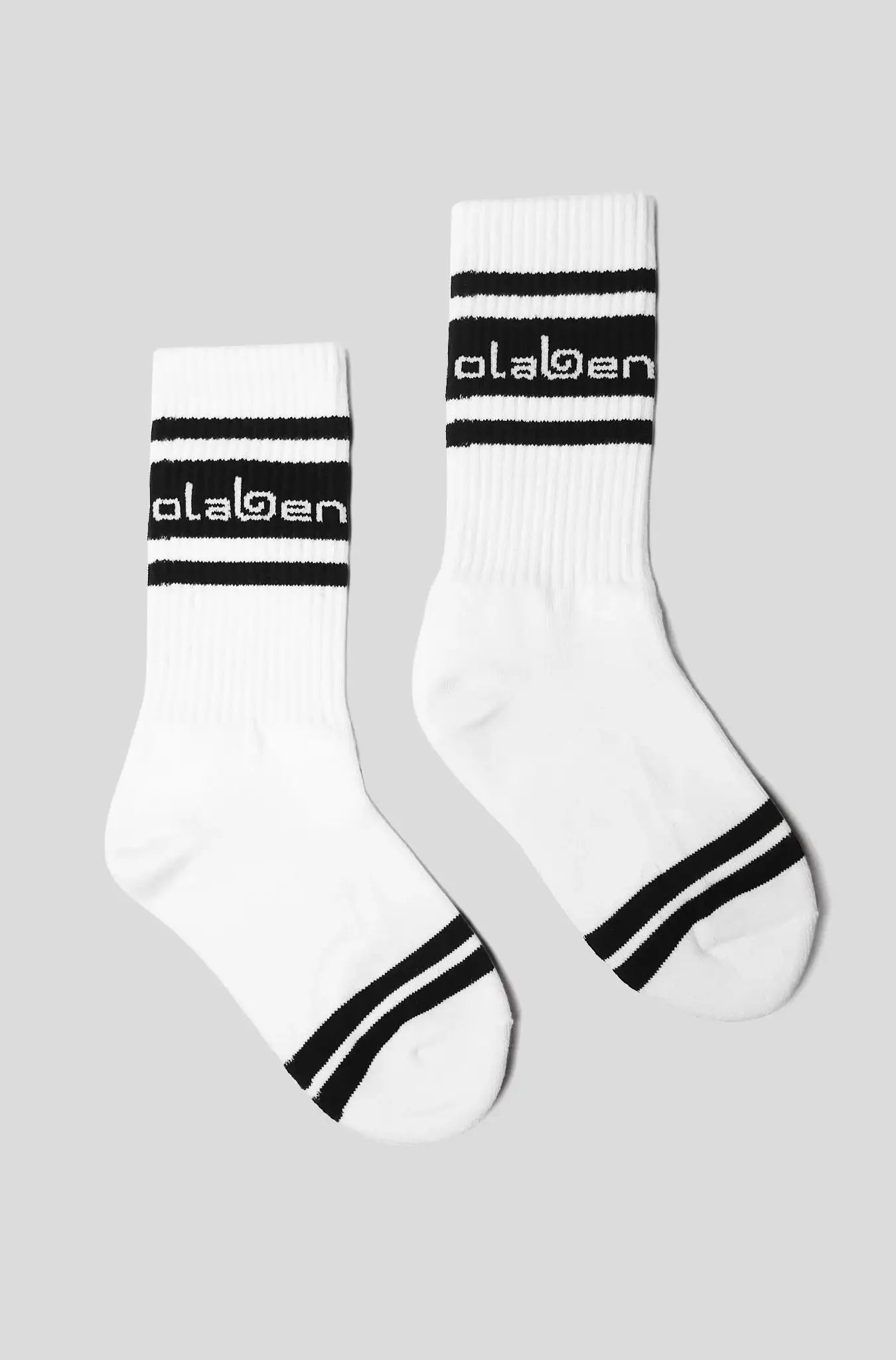 White athletic socks with black stripes and Olaben logo, ideal for fitness and yoga activities.