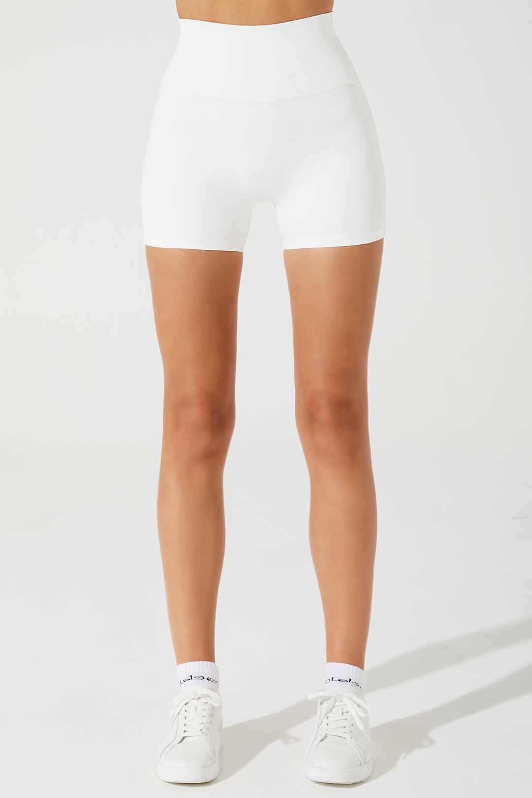 White women's biker shorts with Elvi branding, style OW-0038, in size 2.