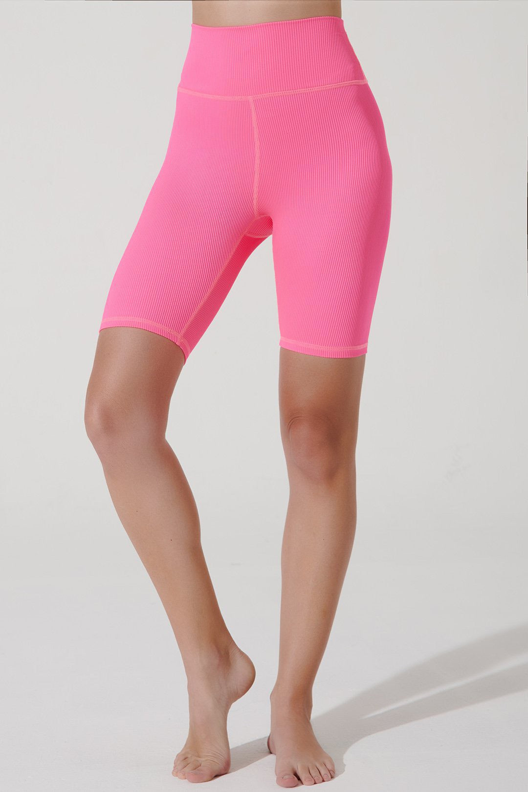 Hot pink ribbed women's shorts with a biker style, perfect for a stylish summer look.