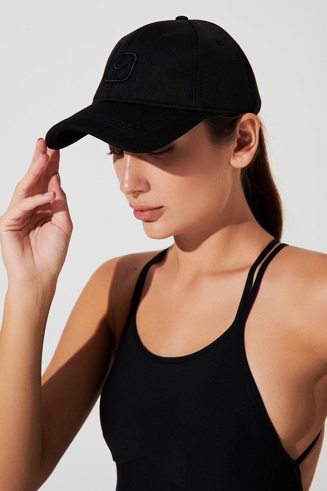 A black baseball cap with the black brand name olaben depicted in the image.