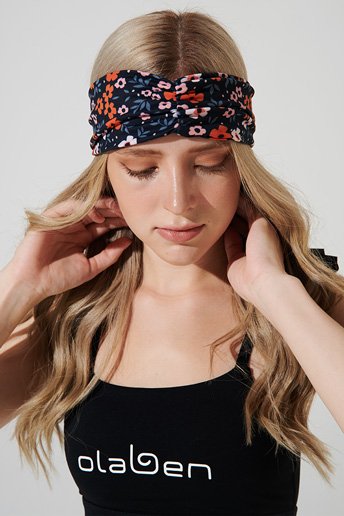 Orange Maja headband with vibrant design, perfect for adding a pop of color to outfits.
