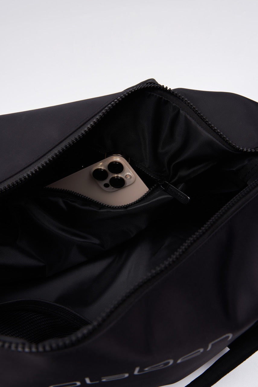 Black duffle bag with two compartments and a sleek design, perfect for travel or gym.