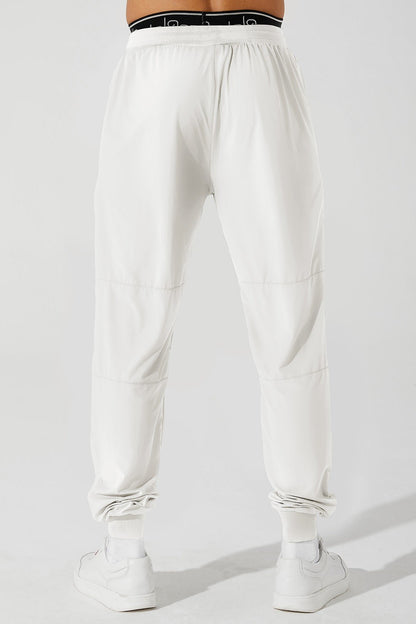 White men's trousers by Travis Pant, style OW-0029-MTR-WT, in a single image.