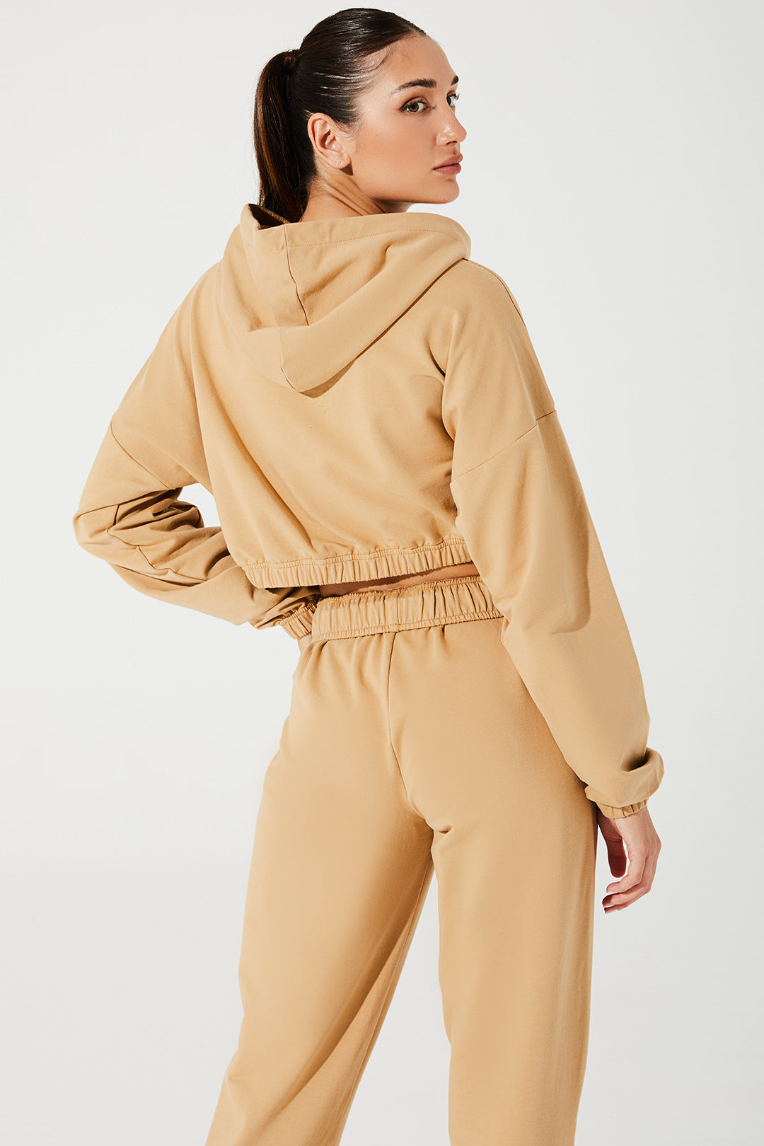 Janet wearing cappuccino beige women's sweatpants, comfortable and stylish, size 4, OW-0036-WSW-BG.